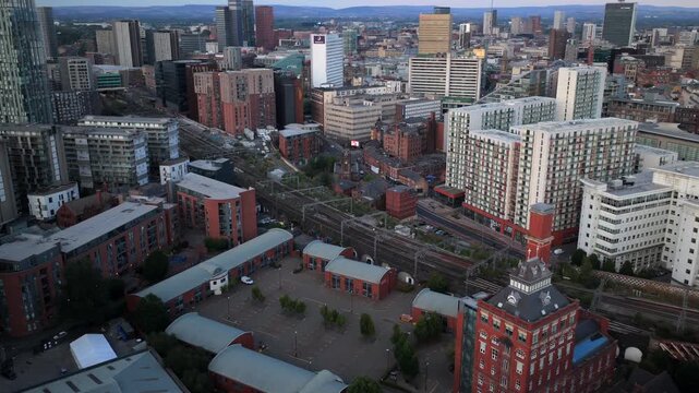 Aerial Video of Salford Central, Railway Line to Victoria Station, and Manchester City Centre Skyline at Dusk