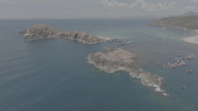 Aerial drone footage of kayaking over seaweed beds at Hon Kho, Gia Lai, Vietnam, featuring crystal-clear water, tropical coastline and an active outdoor adventure near Quy Nhon.