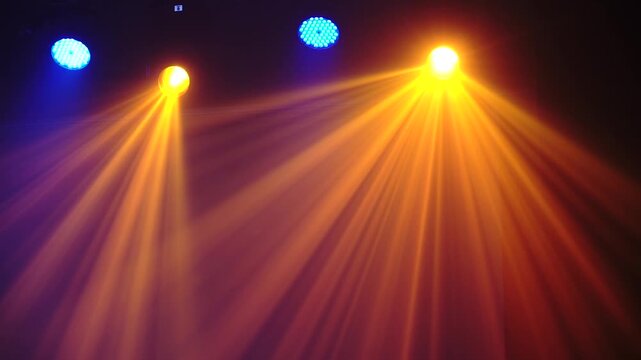 Bright theatrical spotlights shining through atmospheric haze, dynamically changing colors from crisp white to warm orange in a dark event venue.