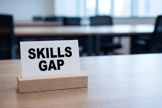 Skills gap sign card on a table in an empty meeting room for workforce shortage talent development recruitment challenge and corporate training need concept
