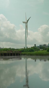 Vertical 9x16 Wind Turbine Generator Over Lake Park