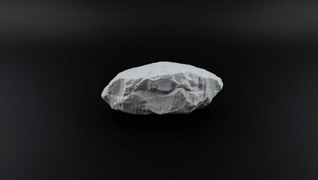 A single grey rock isolated on a dark black background