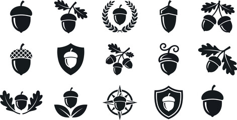 Set of black and white acorn icons featuring various oak nut designs with leaves and decorative emblem shapes © MDMARUF