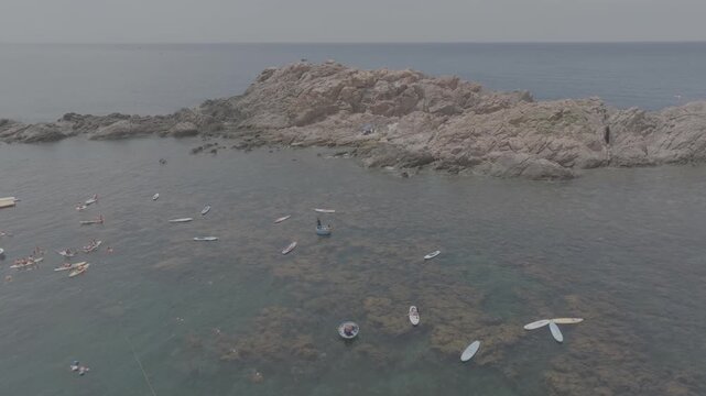 Aerial drone footage of kayaking over seaweed beds at Hon Kho, Gia Lai, Vietnam, featuring crystal-clear water, tropical coastline and an active outdoor adventure near Quy Nhon.