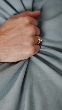 Person, hands and bed with sheet for intimacy, passion or sensual pleasure for lust in home. Top view, woman and grip with fabric, blanket or duvet for romance, sexual desire or arousal in bedroom