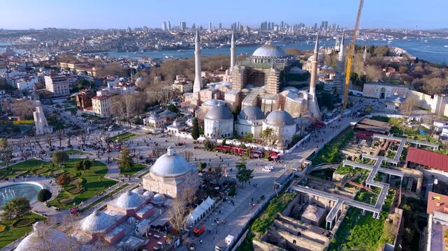 Aerial footage of Hagia Sophia (Ayasofya) in Istanbul, Turkey, captured during restoration work with scaffolding surrounding parts of the historic monument. The iconic Byzantine and Ottoman landmark d