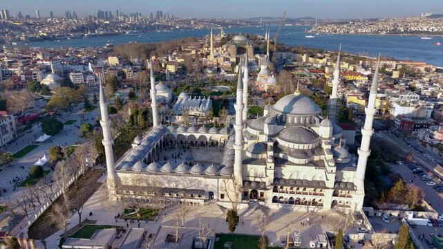 Beautiful aerial view of the iconic Blue Mosque (Sultan Ahmed Mosque) in Istanbul, Turkey, captured during golden hour. The historic Ottoman mosque dominates the skyline with its six elegant minarets 