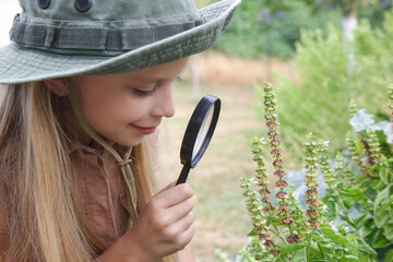 Obraz premium Young Nature Explorer Studying Plants in the Garden