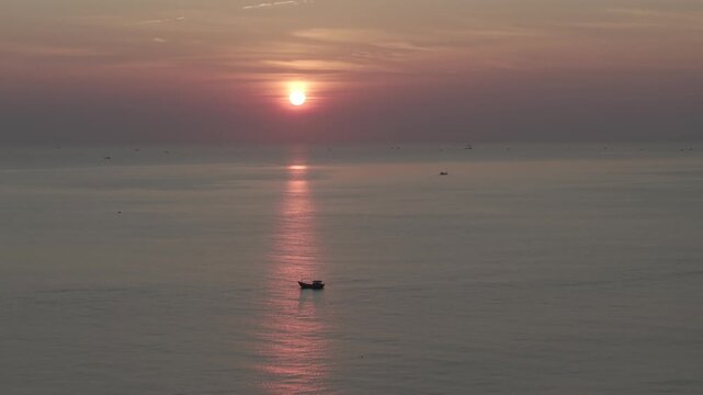 Aerial drone footage of sunrise over Bai Dai Beach, Cam Ranh, Khanh Hoa, Vietnam, featuring golden morning light, turquoise sea, white sand and a pristine tropical coastline.