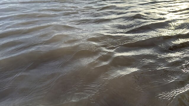 Dynamic water ripples with glinting sunlight creating a mesmerizing surface