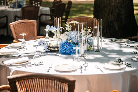 Festive table setting in the garden. Open-air restaurant.