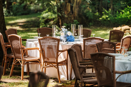 Festive table setting in the garden. Open-air restaurant.
