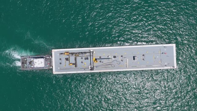 Aerial view cargo barge entering harbor. Cargo business. Container ship. Shipping logistics. Commercial shipping. Cargo barge ship in sea. Freight container loaded on cargo vessel