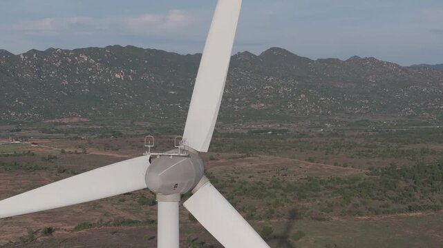 Aerial drone footage of Wind Farm in Phuoc Dinh, Khanh Hoa, Vietnam, featuring giant wind turbines along the coastal landscape, showcasing renewable energy, sustainable power and clean technology.