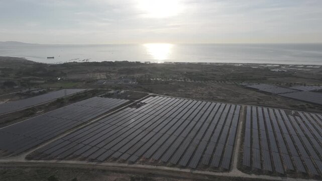 Aerial drone footage of Phuoc Dinh Renewable Energy Complex in Khanh Hoa, Vietnam, featuring solar panels and wind turbines, showcasing clean energy, sustainable power and green technology.