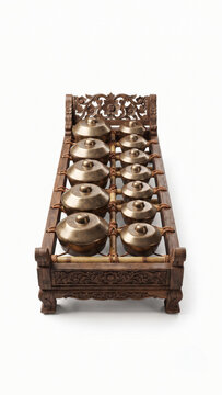 Traditional Javanese Gamelan Bonang instrument isolated on white background, authentic Indonesian bronze kettle gongs.