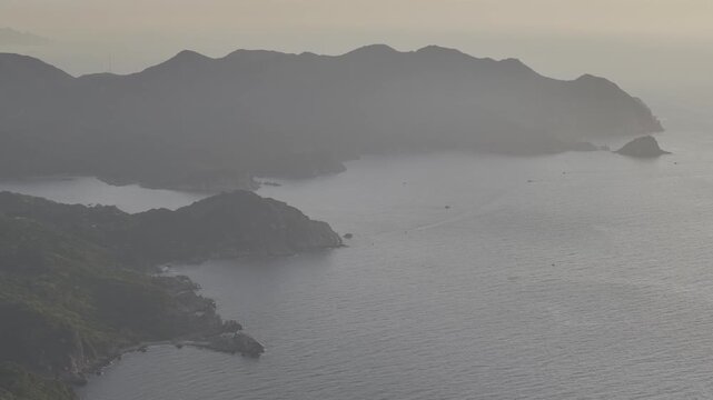 Aerial drone footage of sunrise at Hang Rai, Khanh Hoa, Vietnam, featuring dramatic rocky coastline, turquoise sea, coral reef, golden morning light and breathtaking coastal landscape.