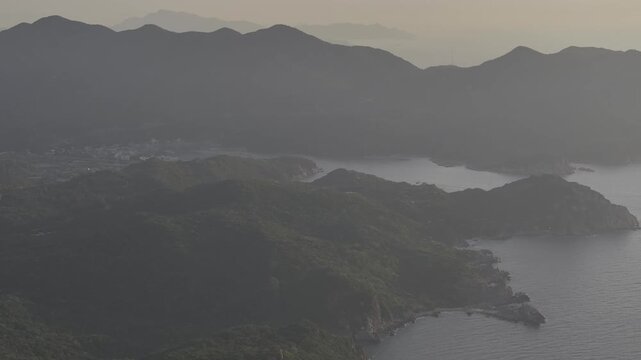 Aerial drone footage of sunrise at Hang Rai, Khanh Hoa, Vietnam, featuring dramatic rocky coastline, turquoise sea, coral reef, golden morning light and breathtaking coastal landscape.