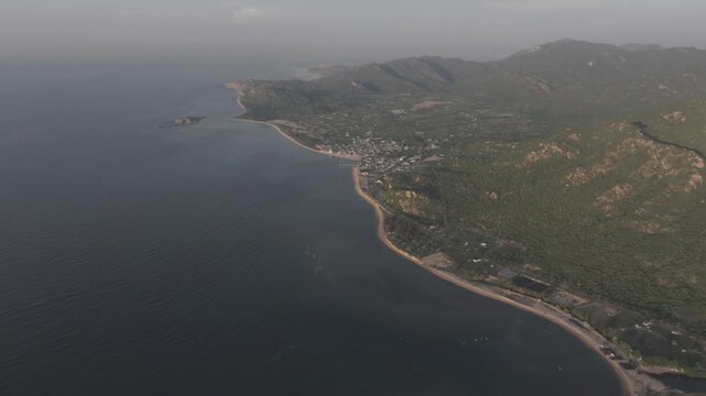 Aerial drone footage of sunrise at Hang Rai, Khanh Hoa, Vietnam, featuring dramatic rocky coastline, turquoise sea, coral reef, golden morning light and breathtaking coastal landscape.