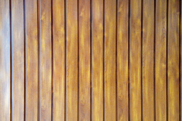 Obraz premium Vertical light brown wood planks background. Natural timber texture with visible grain pattern and vertical lines. Clean wooden wall or floor paneling for interior design and architectural backdrops.