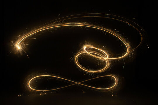 Golden light swirl trail on black background, glowing abstract spark line with particles and long exposure effect for luxury holiday design
