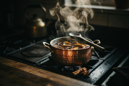 Steaming copper saucepan on modern gas stove, rustic kitchen cooking scene with warm light and wooden countertop for food blog or recipe content