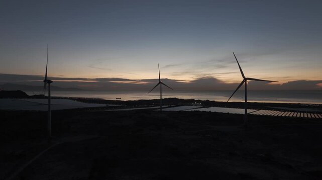 Aerial drone footage of Phuoc Dinh Renewable Energy Complex in Khanh Hoa, Vietnam, featuring solar panels and wind turbines, showcasing clean energy, sustainable power and green technology.