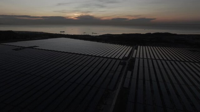 Aerial drone footage of Phuoc Dinh Solar Farm in Khanh Hoa, Vietnam, featuring vast photovoltaic panels, showcasing renewable energy, clean power infrastructure and sustainable technology.