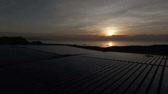 Aerial drone footage of Phuoc Dinh Solar Farm in Khanh Hoa, Vietnam, featuring vast photovoltaic panels, showcasing renewable energy, clean power infrastructure and sustainable technology.