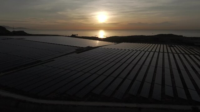 Aerial drone footage of Phuoc Dinh Solar Farm in Khanh Hoa, Vietnam, featuring vast photovoltaic panels, showcasing renewable energy, clean power infrastructure and sustainable technology.