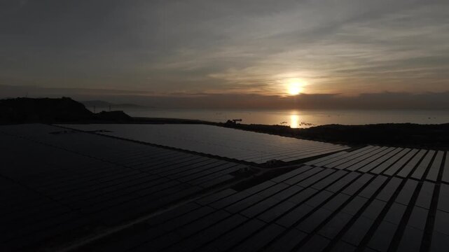Aerial drone footage of Phuoc Dinh Solar Farm in Khanh Hoa, Vietnam, featuring vast photovoltaic panels, showcasing renewable energy, clean power infrastructure and sustainable technology.