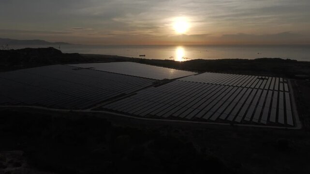 Aerial drone footage of Phuoc Dinh Solar Farm in Khanh Hoa, Vietnam, featuring vast photovoltaic panels, showcasing renewable energy, clean power infrastructure and sustainable technology.