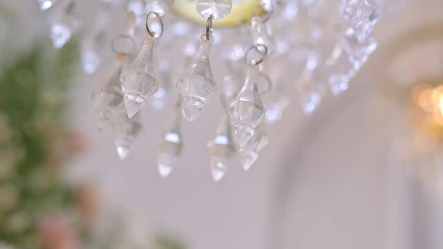 Wedding tent d&eacute;cor dominated by white fabric and hanging lights creates an elegant atmosphere.