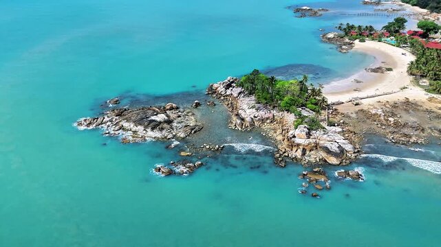 Spectacular Aerial View of Parai Tenggiri Beach Featuring Turquoise Waters, Granite Formations, White Sand, Tropical Resort and Peaceful Coastline
