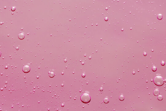 Pink transparent cosmetic product as background, closeup