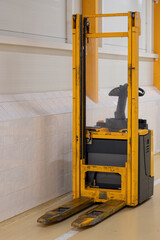 Used forklift in a hallway with tiled walls. © lapis2380
