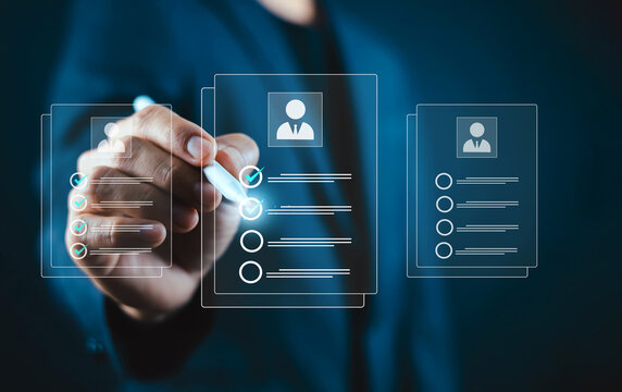 Recruiter using a stylus pen reviewing and selecting candidate resumes or job application profiles. Concept of human resources management, talent acquisition, hiring process, and CV evaluation.