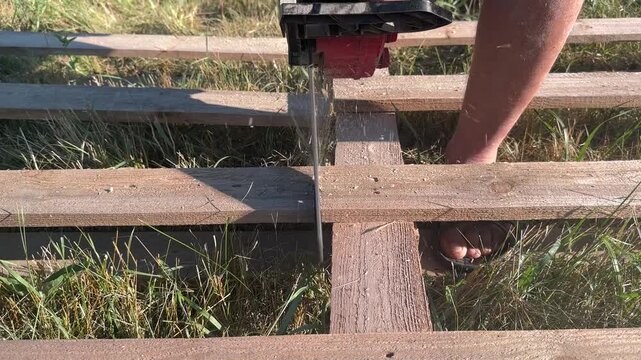 cutting old pallets with a chainsaw close-up . High quality 4k footage