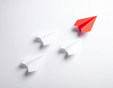 Vibrant red paper airplane soaring upwards isolated on a white background