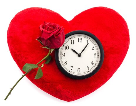 Red heart with flowers and clock symbolizing love and time.