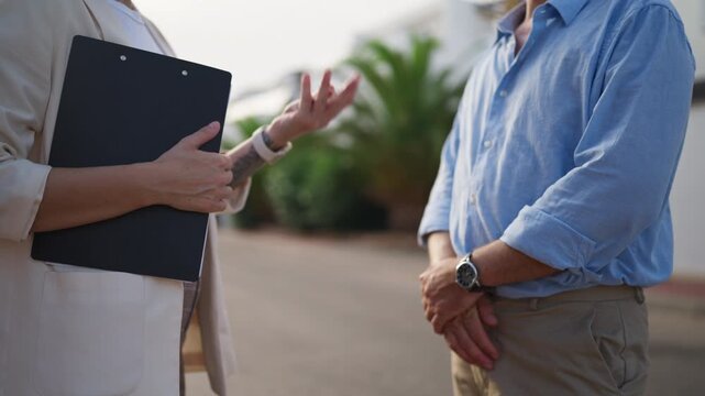 Professional female realtor give keys to new house to male customer. Successful real estate transaction where broker finalizes property sale with new homeowner