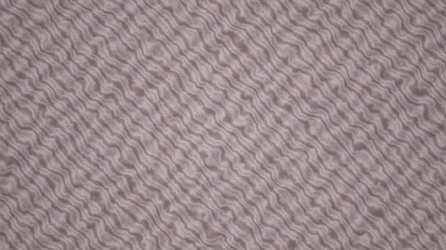 Closeup view of a textured fabric displaying a repetitive wavy pattern in muted gray and beige tones.