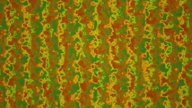 An abstract, mottled surface featuring irregular patches of green, orange, and yellow tones that blend into one another.