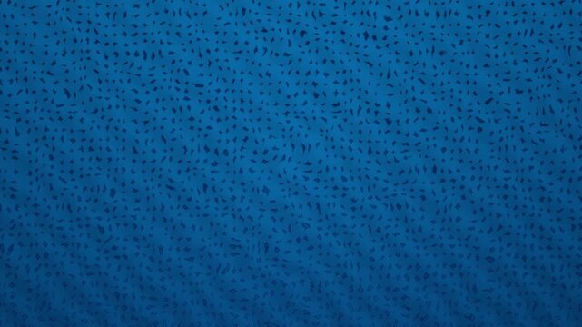 Closeup of textured blue fabric surface with woven pattern and slight lighting variations across the material.