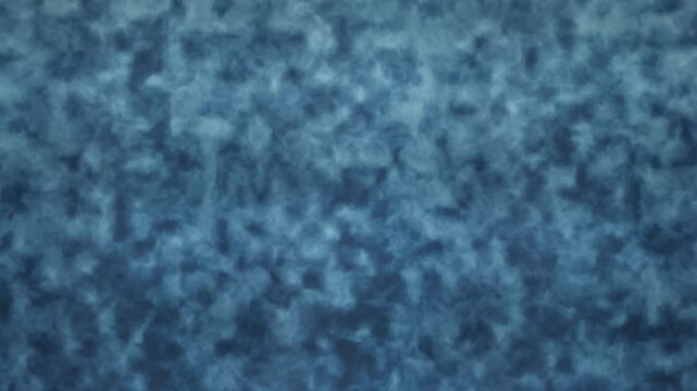 Closeup view of textured blue fabric showing soft woven fibers and subtle color variations across the surface