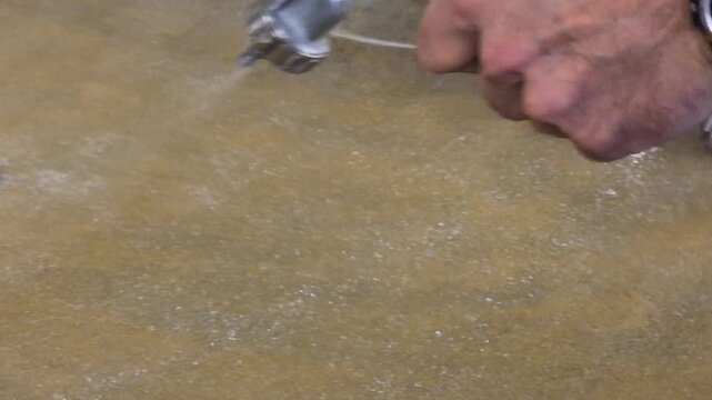 Painting spraying headliner auto mechanic applying adhesive with a spray gun during car interior repair and restoration