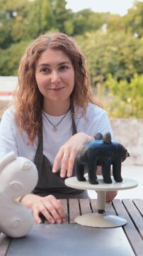 Ceramic Artist Displaying Handmade Sculptures Outdoors