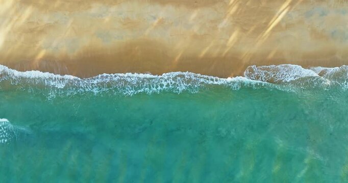 Beautiful sea summer landscape, Waves sea water surface High quality video Bird's eye view, Drone top view waves crashing on sand beach,Nature ocean sea beach background