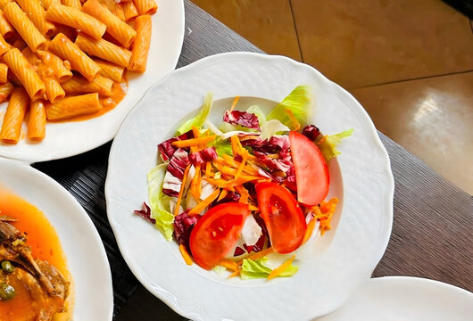Fresh Garden Salad with Tomatoes and Shredded Carrots on White Plate