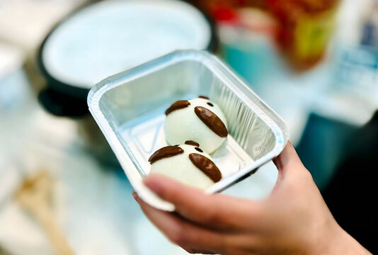 Hand Holding Aluminum Tray with Two Cute Panda Shaped Steamed Buns